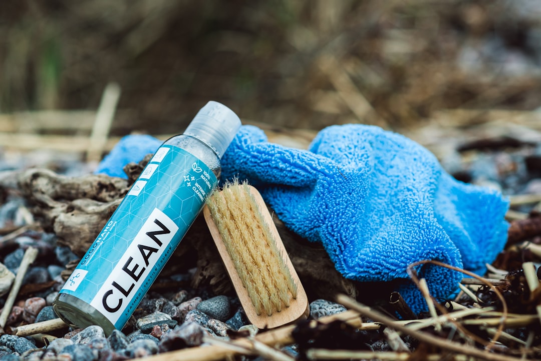 services-03 a-close-up-of-a-blue-glove-and-a-tube-of-clean-vjd2z05nkfs